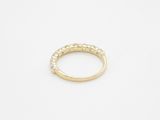 a yellow gold ring with small white diamonds on it
