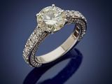 an engagement ring with a round brilliant cut diamond set in 18k white gold