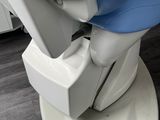 a white toilet with a blue seat and a white sink