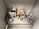 a shelf that has many different types of paint on it