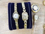 two watches and a bracelet on a table