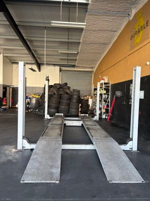 an image of a garage with a lot of tires on the floor