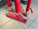 a red pole that is sitting on the ground