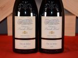 two bottles of wine that are sitting on a table