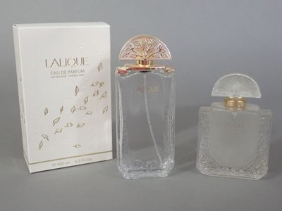 an image of a bottle of perfume next to a box on a table