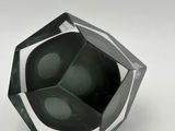 an image of a black and silver glass bowl on a white surface