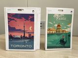 two boxes that have a picture of a city and a boat on them
