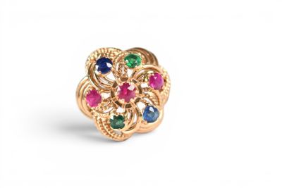 a close up of a gold ring with multi colored stones