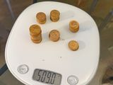 a white scale with some cookies on it on a table