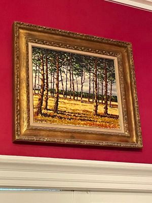 a picture of a painting hanging on a red wall