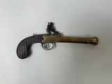 an old brass revolver with a wooden handle on a white surface