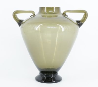 a green vase with two handles on a black base