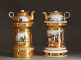two gold vases with pictures of people on them