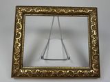 gold frame with a triangle in it on a white surface