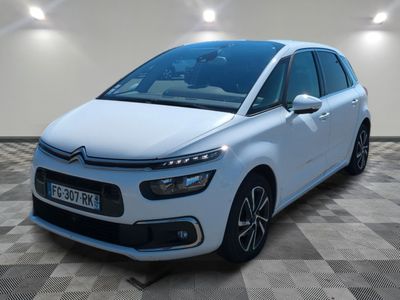 a white citrole is parked in a room with checkered floor