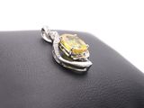 yellow sapphire and diamond pendant on a black leather purse