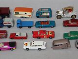 a lot of toy cars and trucks that are on the table