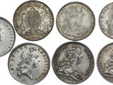 a group of six silver coins of various sizes and shapes