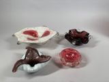 three small glass bowls and a bowl with a bird on it