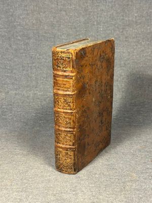 an old book sitting on top of a gray surface
