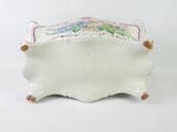 a small white box with a floral design on it