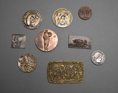 several different types of silver and gold coins on a gray surface