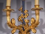 a gold candle holder with three candles on it