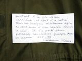 a piece of paper on a jacket with writing on it