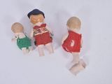 three wooden dolls that are standing next to each other