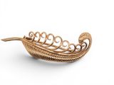 a close up of a gold plated brooch on a white background