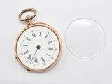 a gold pocket watch with roman numerals on it