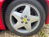 tire of a red sports car with a smiley face painted on it