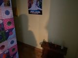 a picture of a refrigerator in a room with a poster on the wall