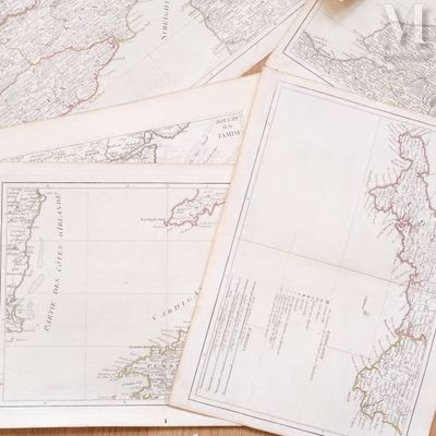 many maps of the world on a table with a cup of coffee