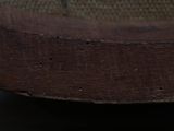 a close up view of a brown shoe with holes in it