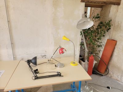 a desk with a lamp and a chair in a room