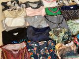 many different types of clothes laid out on the floor
