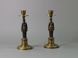 pair of antique brass candlesticks with figures on each of them