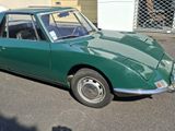 a green car that is parked in the parking lot