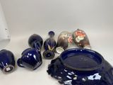 a lot of blue vases sitting on a table