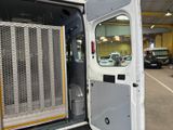 a white van with its door open in a garage