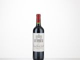 a bottle of red wine sitting on top of a table