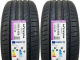a pair of tires with labels on them for sale on a white background