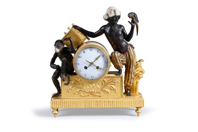 a gold clock with a statue of a man holding a bird