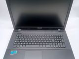 the asus laptop is sitting on a white surface with a blue sticker
