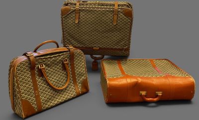 three pieces of luggage sitting next to each other on a gray surface
