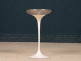 a small white table with a gold rim on it