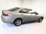 a picture of a silver car in a white room