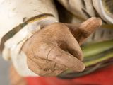 a statue of a man holding a banana in his hand