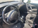 the interior of a small car with a steering wheel and dashboard